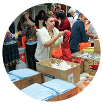 Employees sorting through boxes of donations.